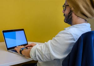 A focused individual working at a clean desk with no distractions around.