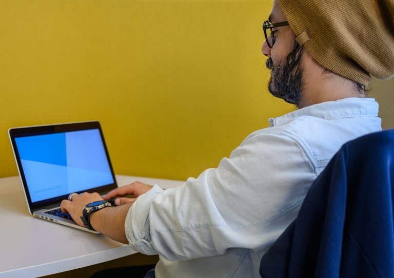 A focused individual working at a clean desk with no distractions around.