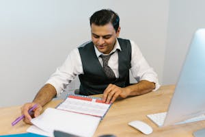A person planning their day with a calendar, a clock, and a to-do list, representing organized time management.