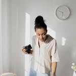 A clock with a person multitasking small tasks around it