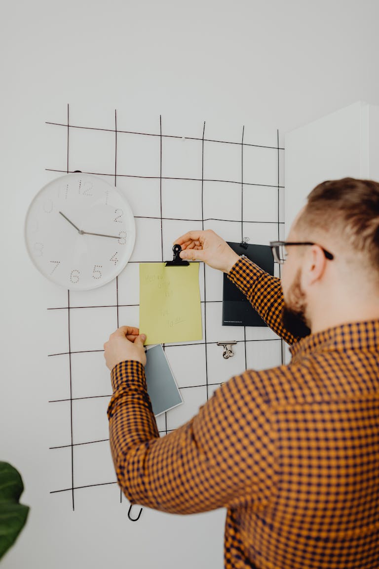 A checklist being marked with a pen, or a person organizing tasks on a whiteboard