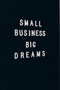 A checklist or a small domino knocking down larger dominoes, symbolizing small actions leading to big results.