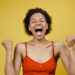 A person smiling in a bright, uplifting setting, symbolizing optimism and positive thinking.