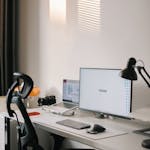 A clean, simple workspace with a small jar of cash and minimal clutter
