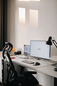 A clean, simple workspace with a small jar of cash and minimal clutter