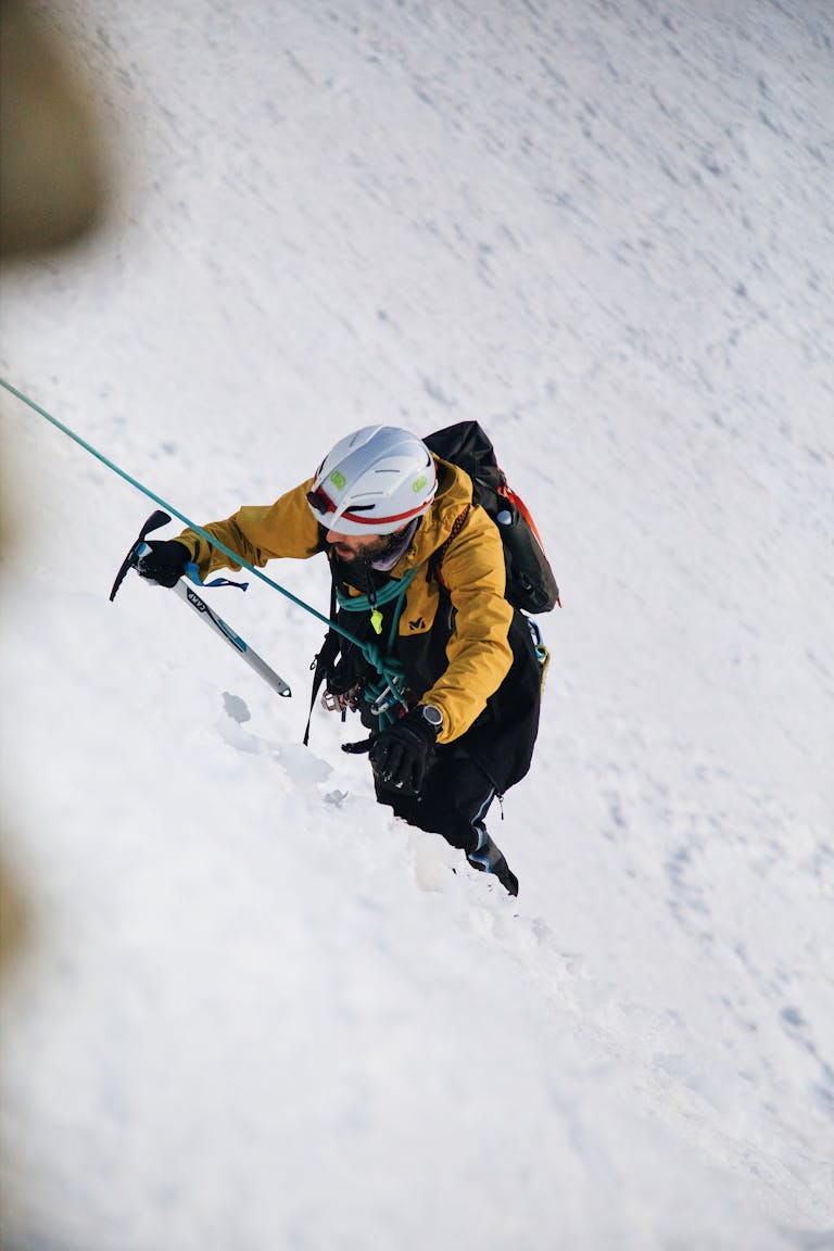 A person climbing a mountain or navigating through a storm with determination.
