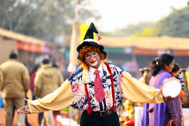A confident person holding up a calm hand, with a blurred crowd in the background.