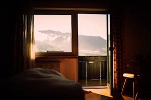 Sunrise with someone journaling or stretching near a window.