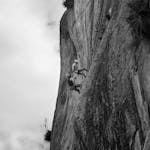 A mountain climber facing a storm, symbolizing inner strength
