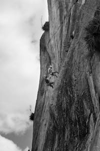 A mountain climber facing a storm, symbolizing inner strength