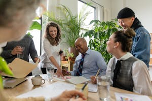 A team of professionals discussing a business strategy with eco-friendly elements, like green plants and sustainability icons, in the background.