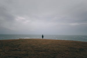 A peaceful nature scene, possibly with a person meditating or taking a walk in a calm environment.
