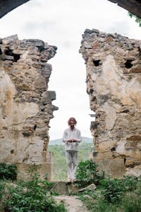 A person standing at the base of a mountain labeled “My Goal,” with broken signposts and a fresh path laid ahead.