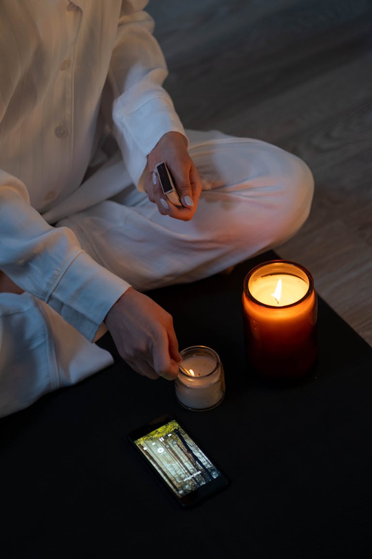 A person meditating in a serene environment with a smartphone turned off or placed aside