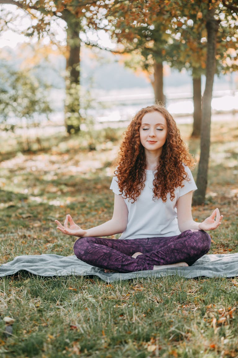 A person meditating in nature, surrounded by calm and serenity