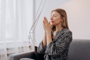A person meditating with their phone set aside, symbolizing a healthy digital detox.