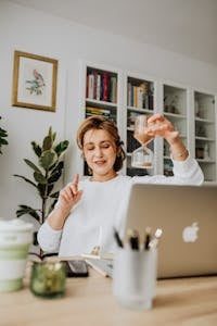 A person stretching at their desk with a timer showing a 5-minute break.