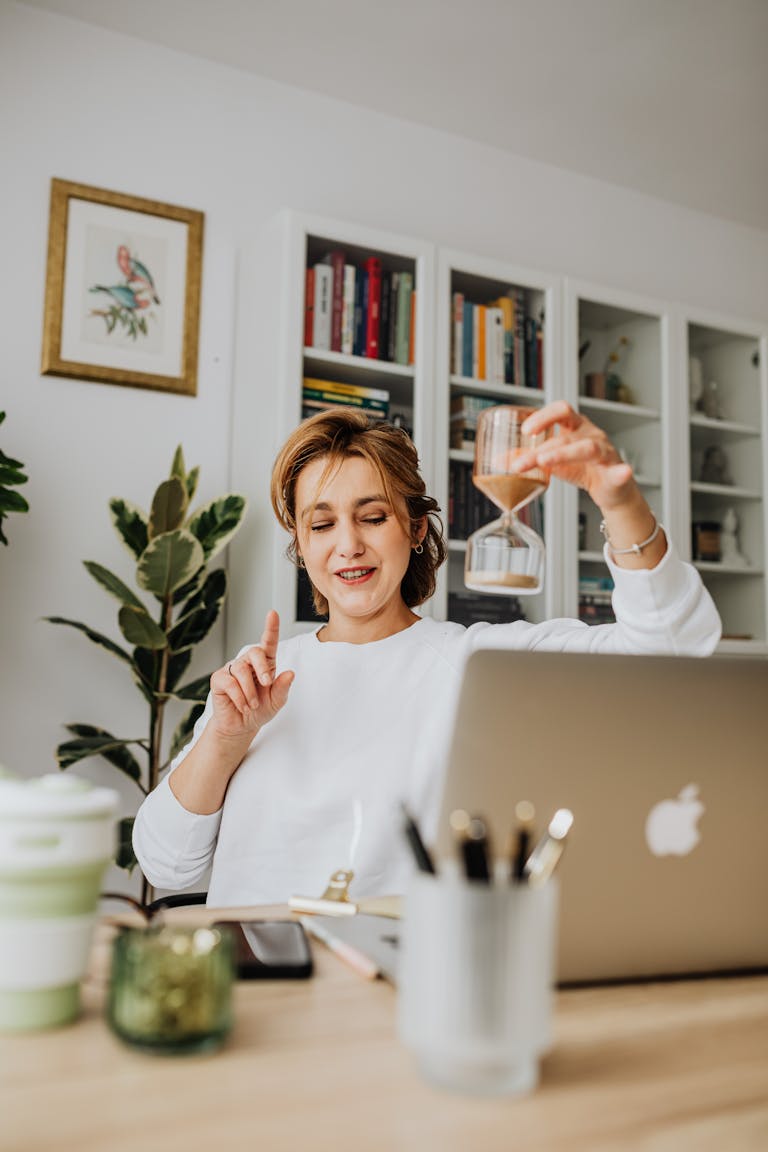 A person stretching at their desk with a timer showing a 5-minute break.
