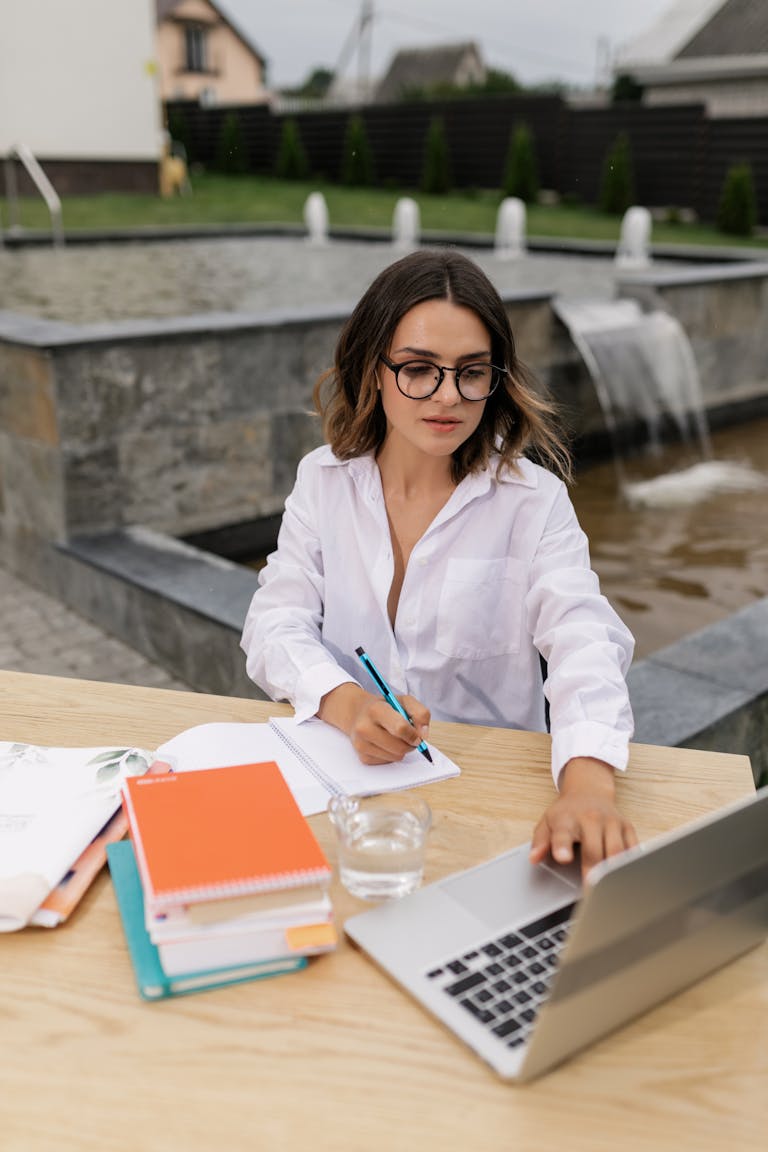 A person using a laptop in a focused and organized workspace.