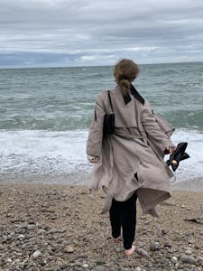 A person walking in nature with their phone turned off, enjoying the present moment.