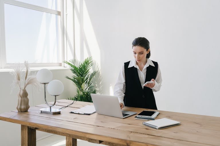 A clean, organized home office with a person working at a desk, free from distractions, using productivity tools.