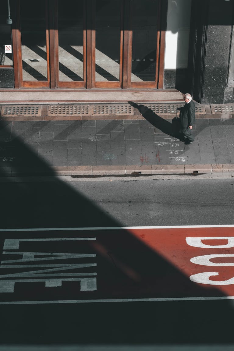 A person standing at a crossroads with signs reading “Old Success” and “New Path”