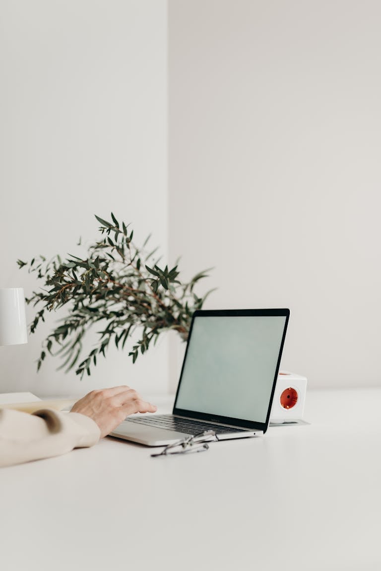 A minimalist workspace with a clean laptop screen and no digital notifications.