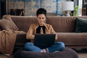 A person working from home with a clear boundary between work and personal life, possibly using a laptop, with a balanced workspace featuring elements of relaxation and productivity.