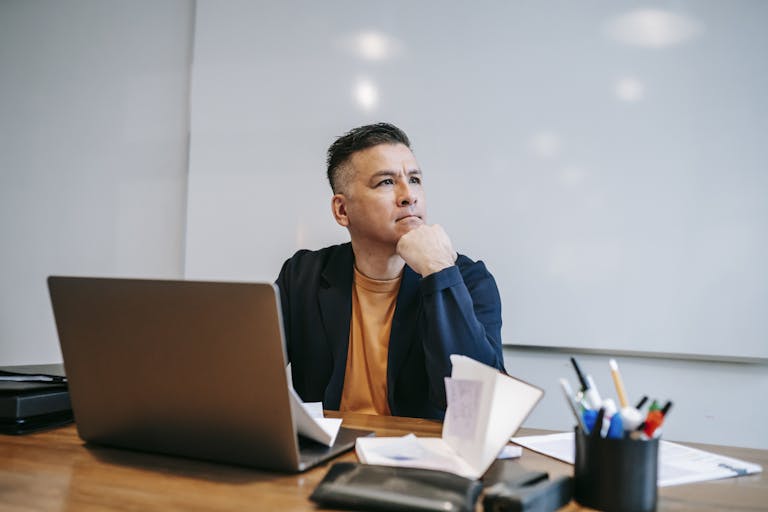 A person working at a desk with focus, turning away from distractions.