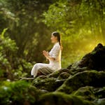 A person meditating in a calm, serene environment