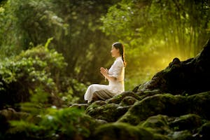 A person meditating in a calm, serene environment