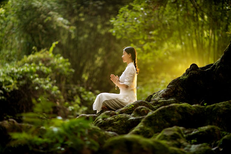 A person meditating in a calm, serene environment