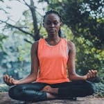 A person meditating in nature with their phone turned off