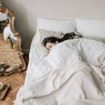 A cozy bedroom setup with soft lighting and a person peacefully sleeping