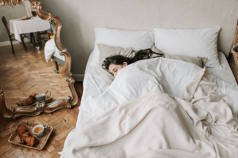 A cozy bedroom setup with soft lighting and a person peacefully sleeping