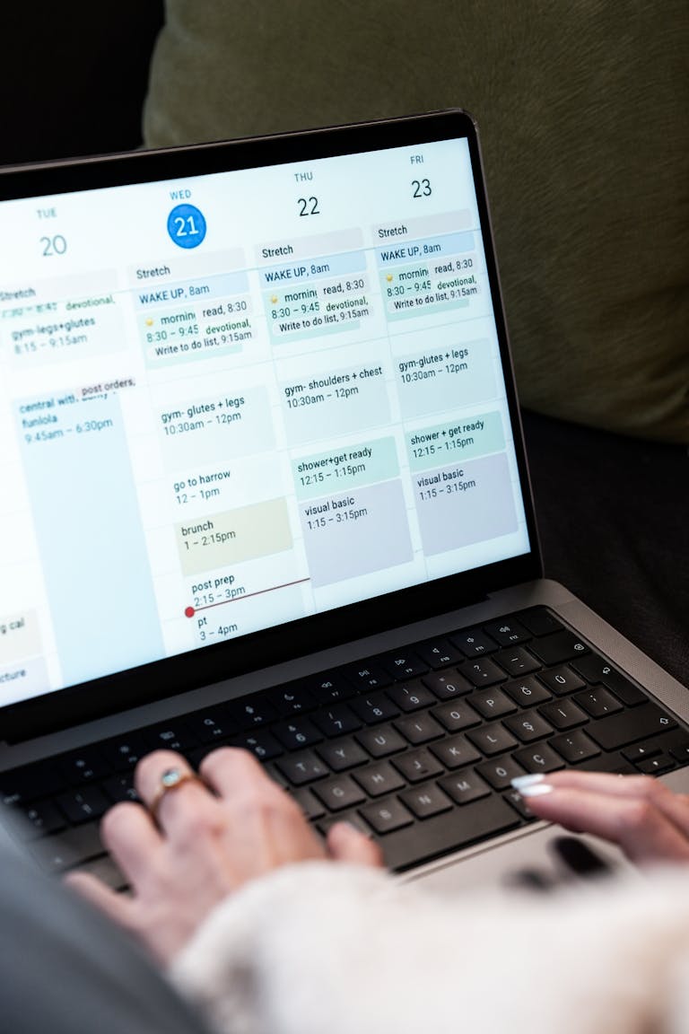 A person planning their day using a planner or digital calendar, with time slots visible