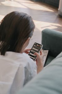 A person scrolling through their phone, with a clear contrast between focused work on one side and distracted scrolling on the other.
