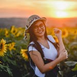 A person smiling while looking at a sunrise or a happy person engaging in an uplifting activity