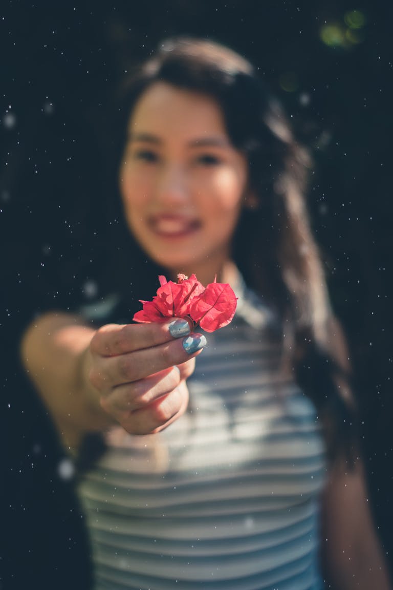 A person confidently holding up their hand with a soft smile, symbolizing a respectful “no.”