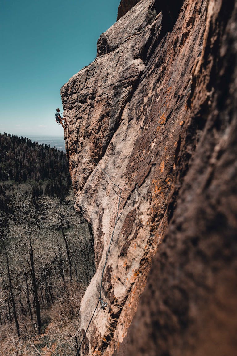 A person climbing out of a hole into sunlight, symbolizing breakthrough and renewed energy.