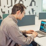 A person updating their LinkedIn profile on a laptop or a professional headshot.