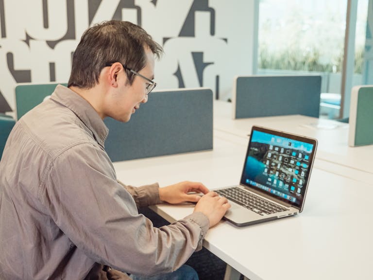 A person updating their LinkedIn profile on a laptop or a professional headshot.