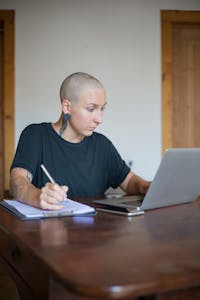 A person meditating or working at a desk with a clean, organized workspace, looking focused.