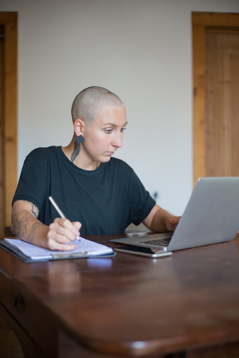 A person meditating or working at a desk with a clean, organized workspace, looking focused.