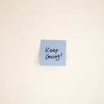 A ticking clock next to a small sticky note that says “Just Start”
