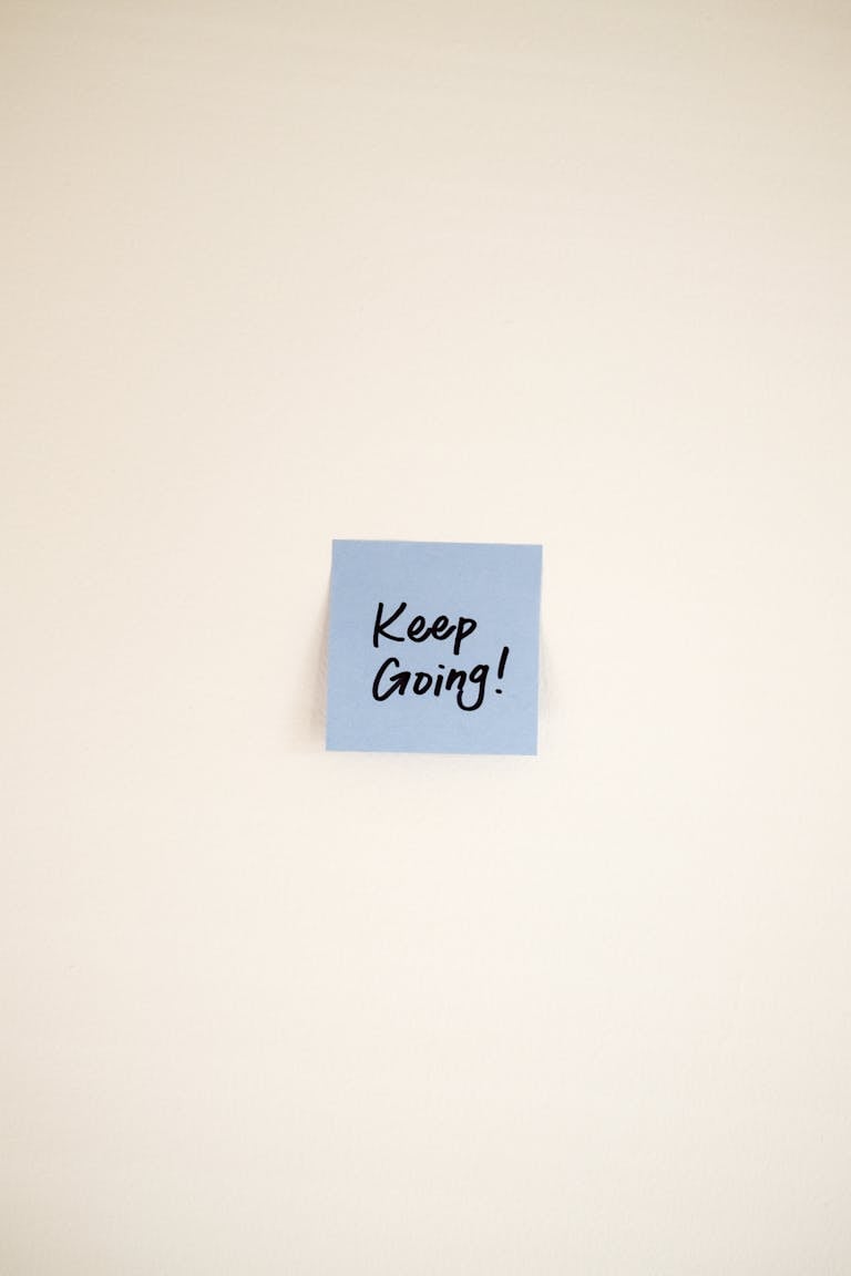 A ticking clock next to a small sticky note that says “Just Start”