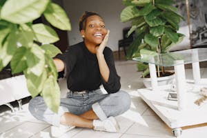 A person turning off multiple devices with a peaceful expression, surrounded by nature or a clean desk space.