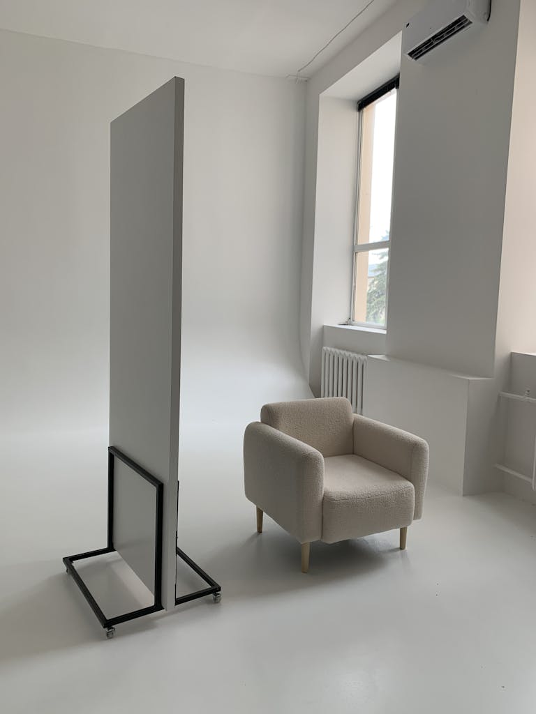 A clean, simple living space with minimalist furniture and natural light streaming in.