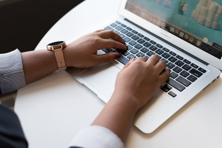 A person efficiently working at a computer with shortcut key symbols floating around