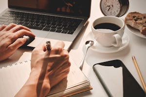 A calm workspace with a clock, notebook, and coffee—symbolizing peace and control over time.